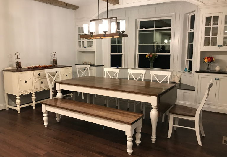 handmade bench, table, and chairs in a modern farmhouse dining room.